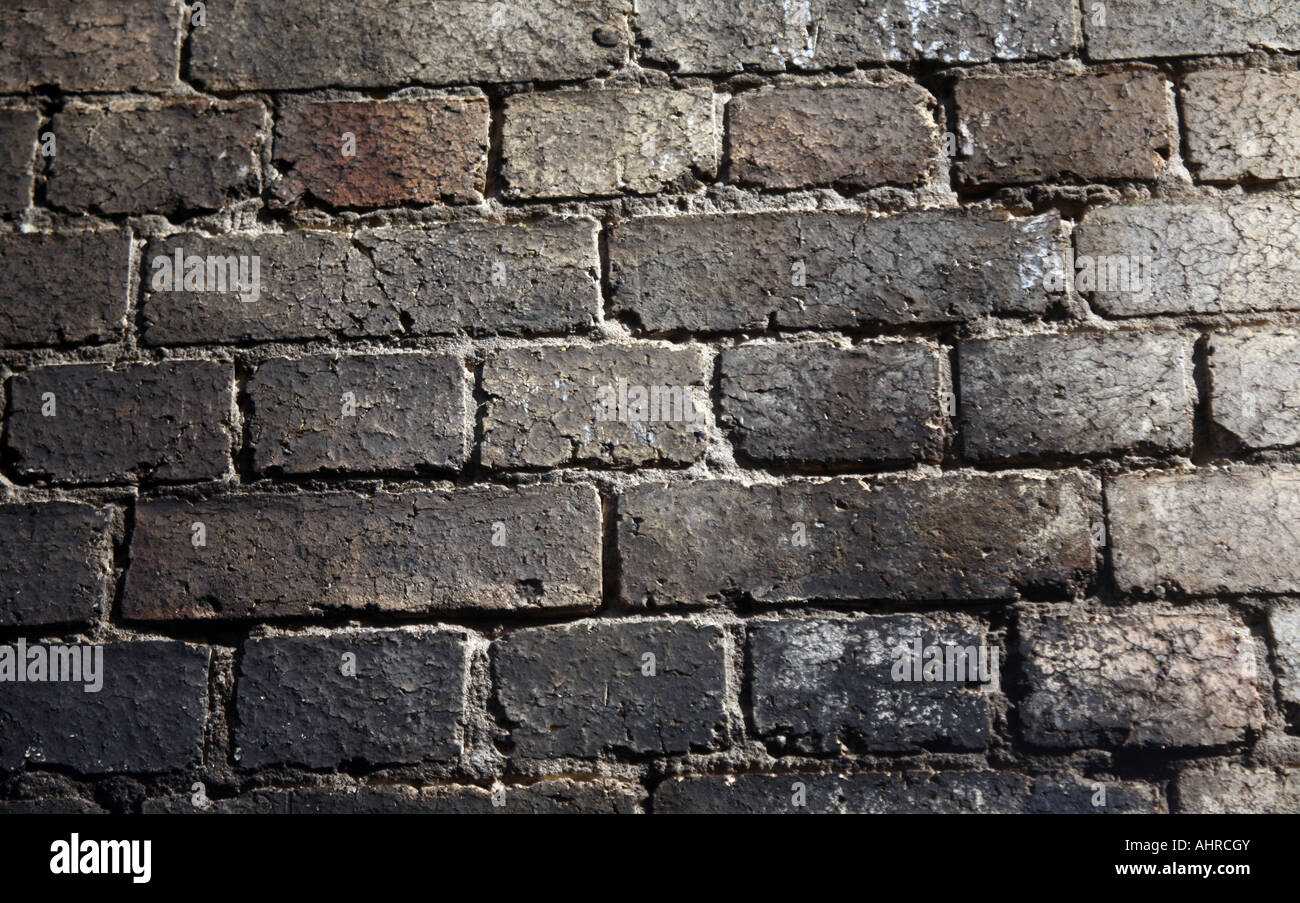 Alte abgenutzte strukturierte gebrannte Mauer Stockfoto