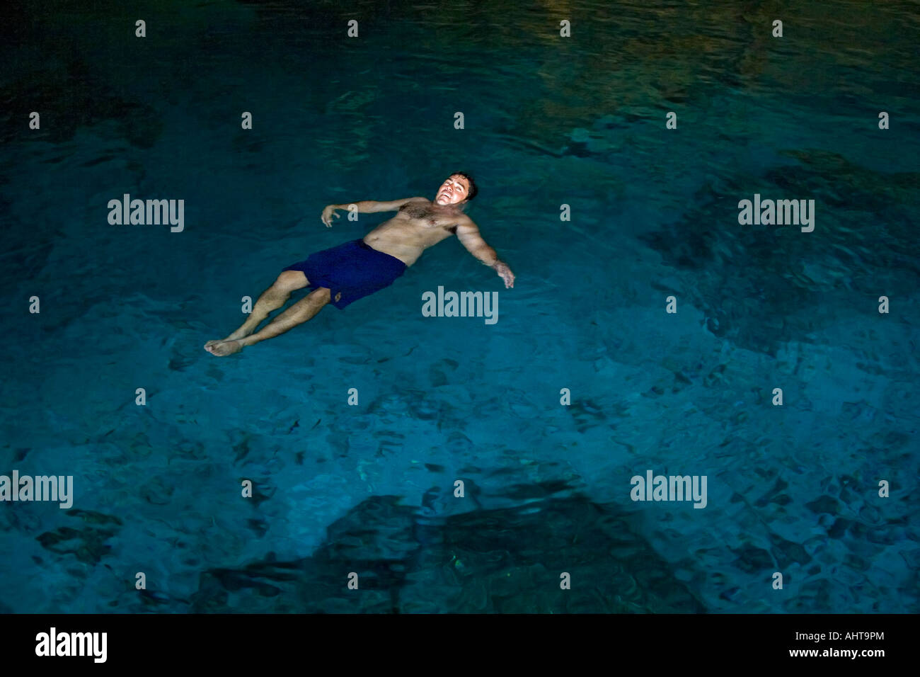 Ein Schwimmer schwimmt auf dem Rücken in der Cenote "Zwei Augen" (Mexiko). Homme Faisant la Planche Dans le Cénote Dos Ojos (Mexiko). Stockfoto