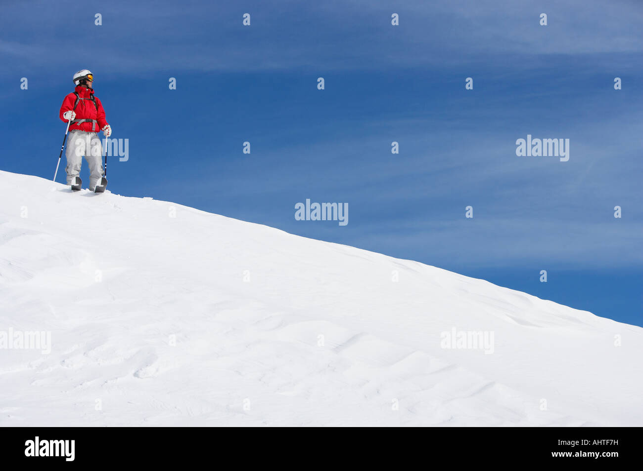 Männlichen Skifahrer auf schneebedeckten Hang stehend Stockfoto