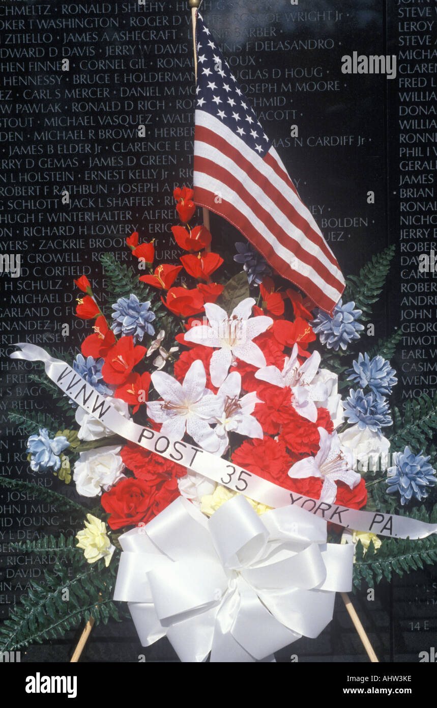 Flagge und Blumen vor Vietnam Wall Memorial Washington D C Stockfoto