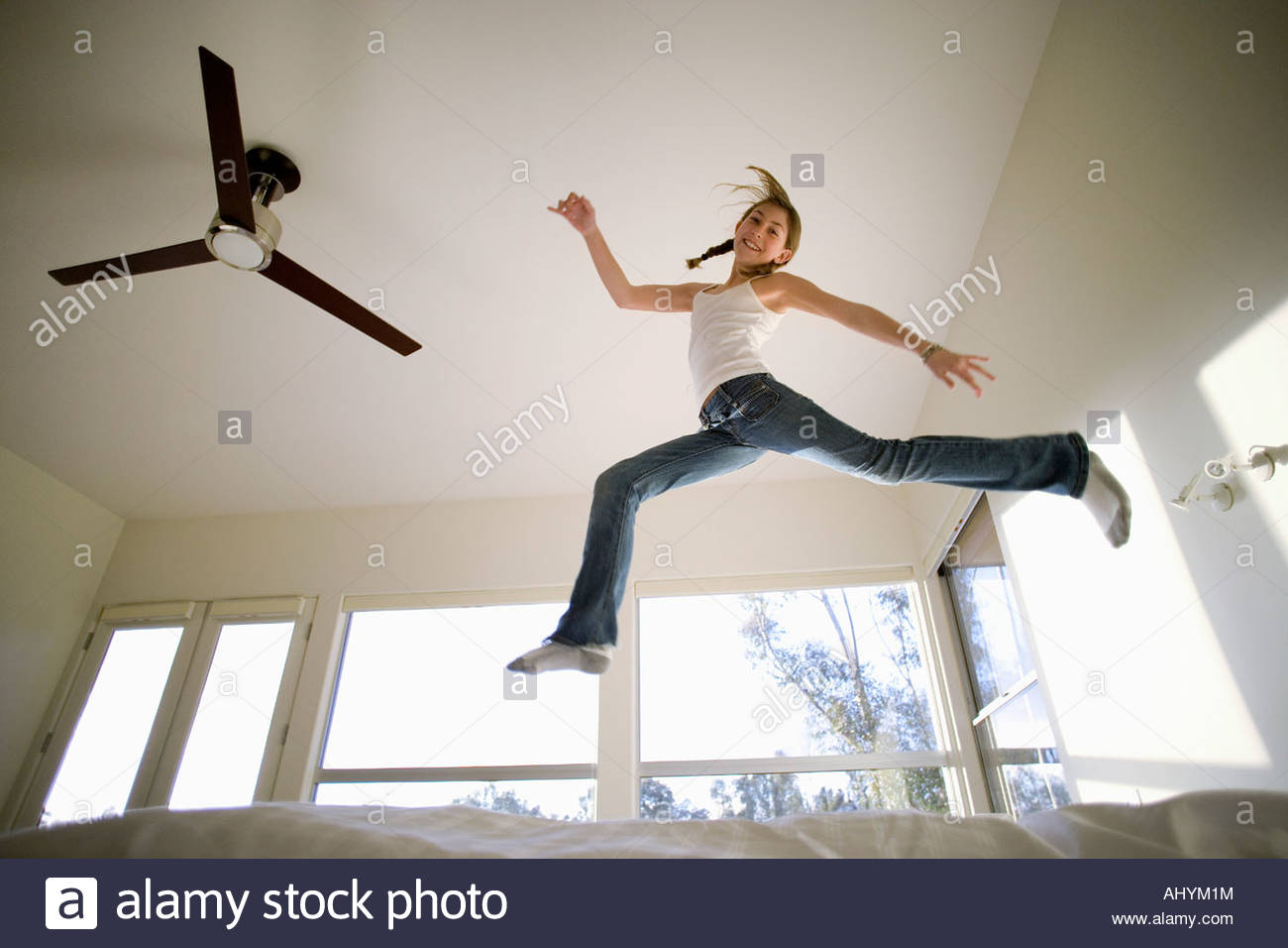 Teenage Girl Jumping On Bed Stockfotos Teenage Girl