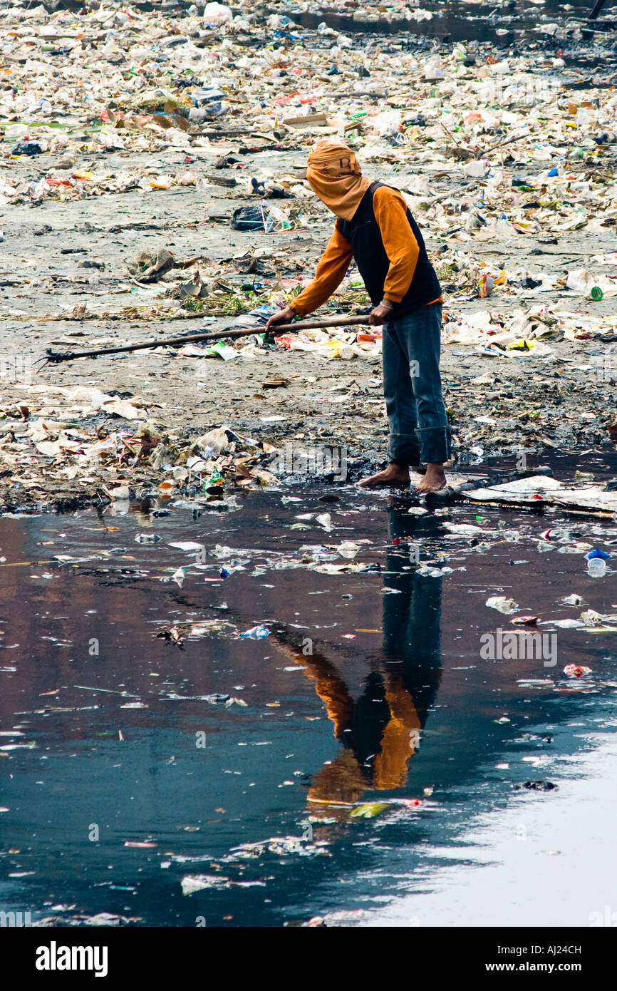 Junger Mann Kommissionierung durch Ciliwung Fluß der Müll für die Brocken von Wert Jakarta Indonesien Stockfoto