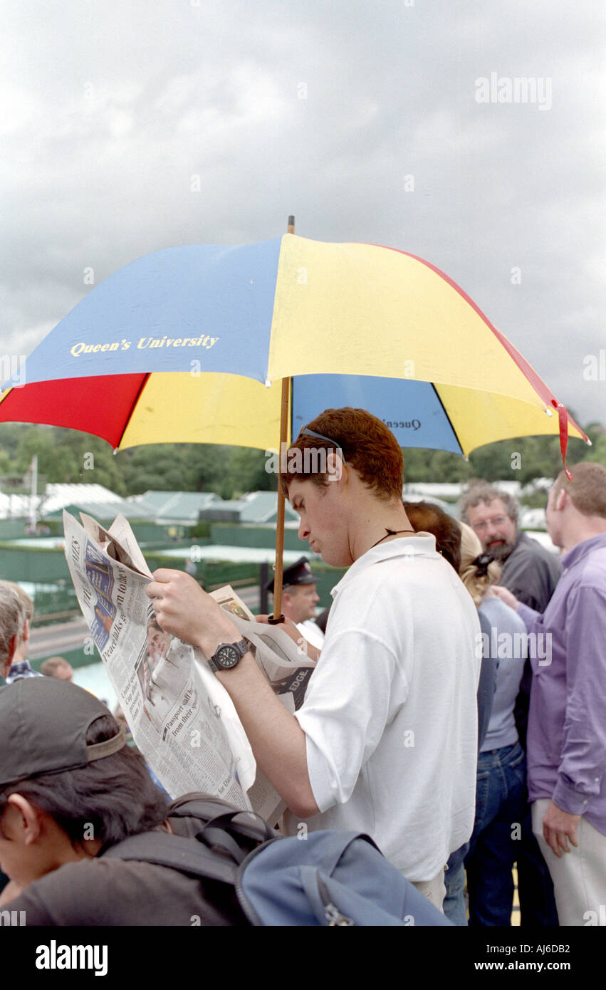 Mann liest Zeitung im Wimbledon Tennis in London UK Stockfoto