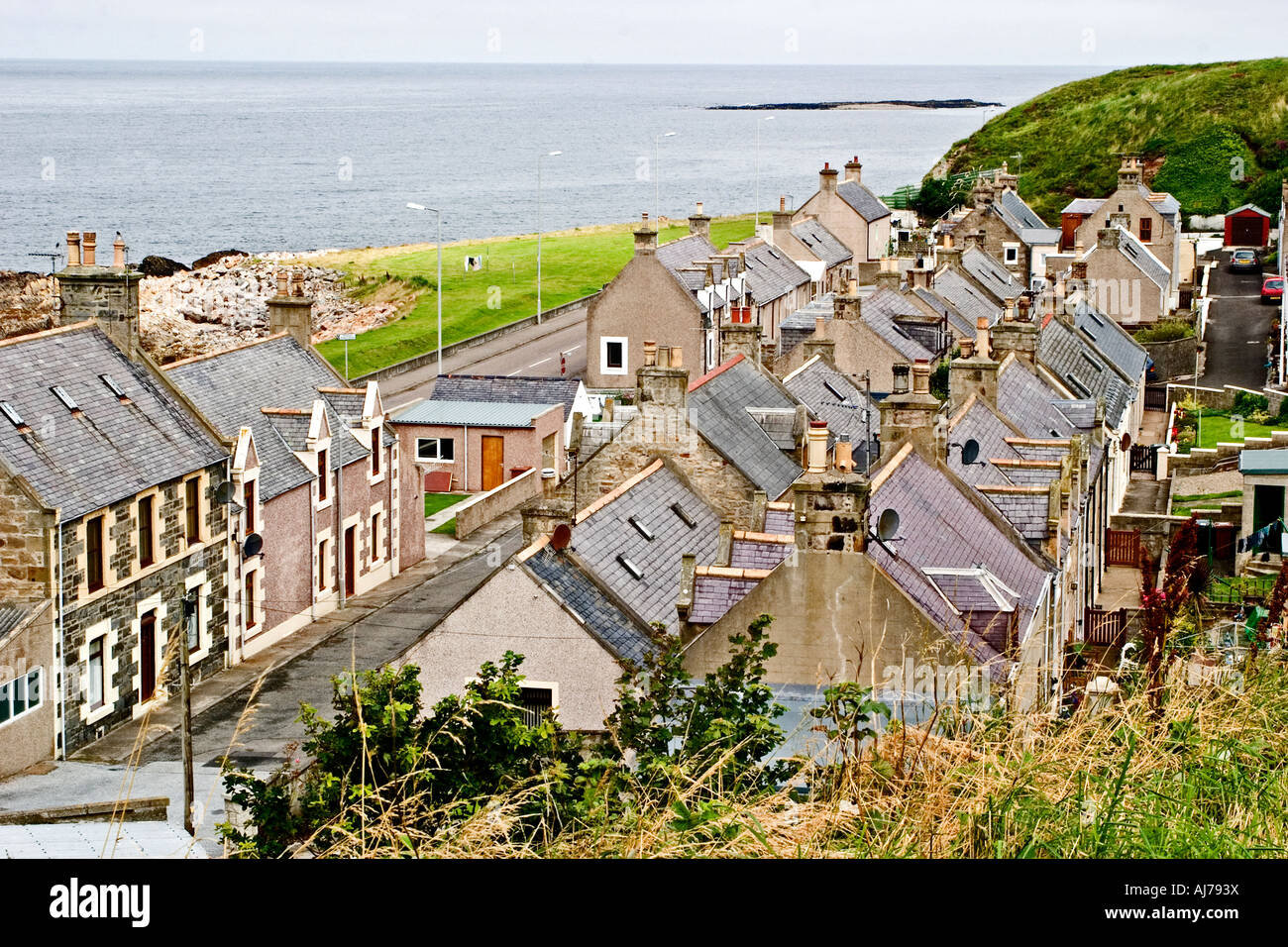 Die Dächer von Fisher Häuser, Buckie, Moray, Schottland mit den Moray Firth und die Insel Craigenroan im Hintergrund. Stockfoto