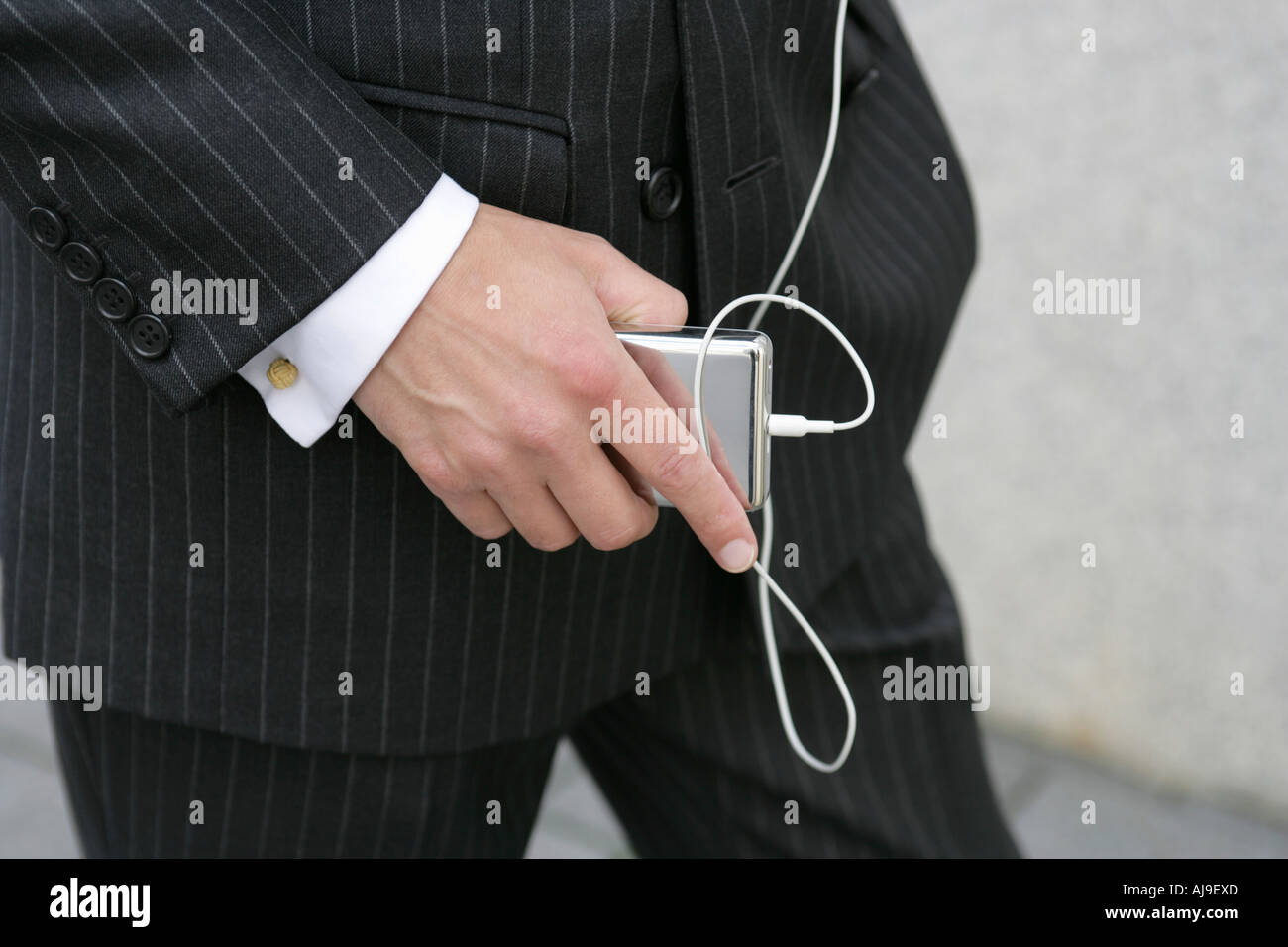 Ein Business-Mann hält einen MP3-player Stockfoto