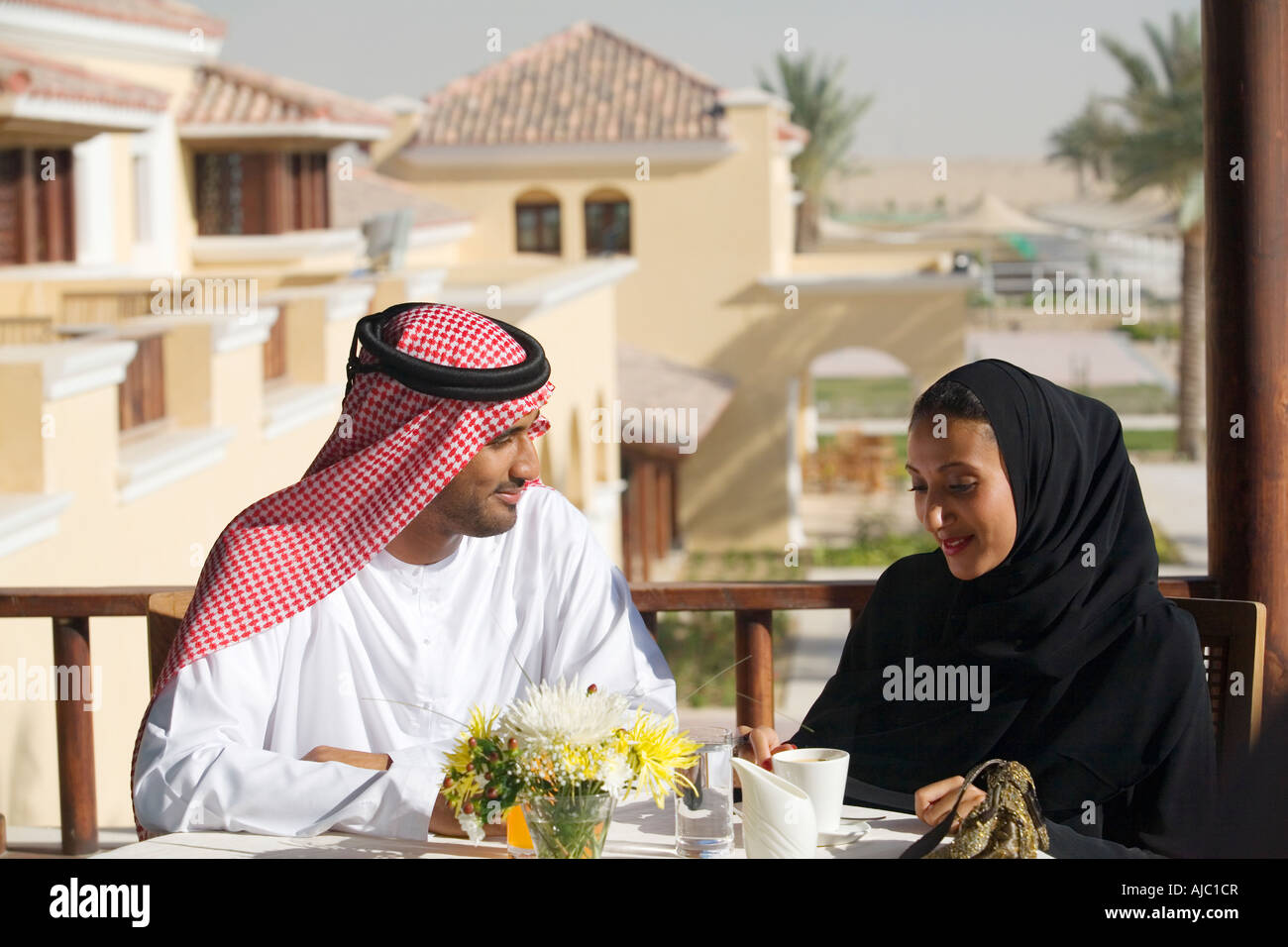 Lächelnde Arabische Mann und Frau Kaffeetrinken auf Balkon Stockfoto