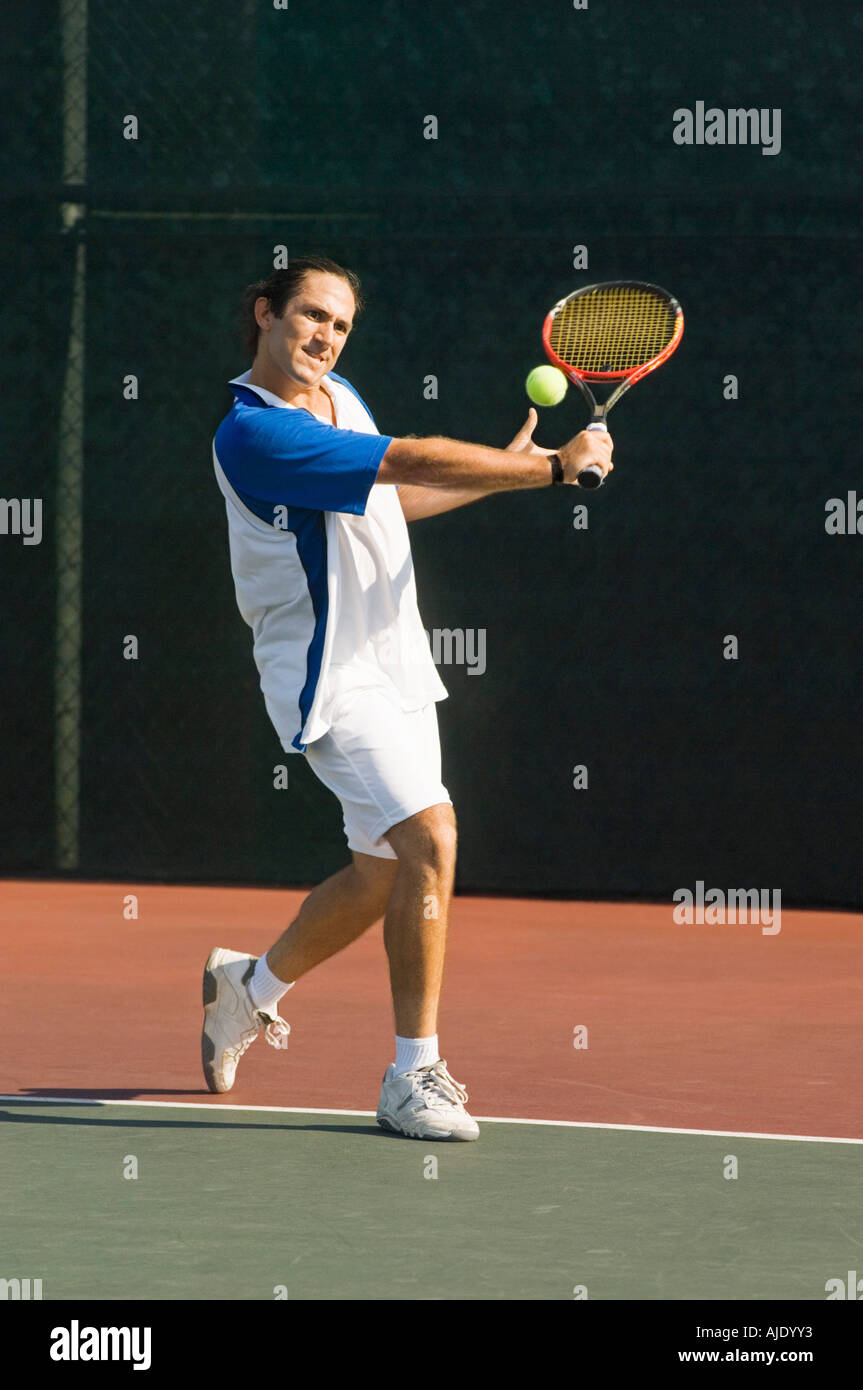 Tennisspieler auf Platz, Tennisball mit der Rückhand zurück wird vorbereitet Stockfoto