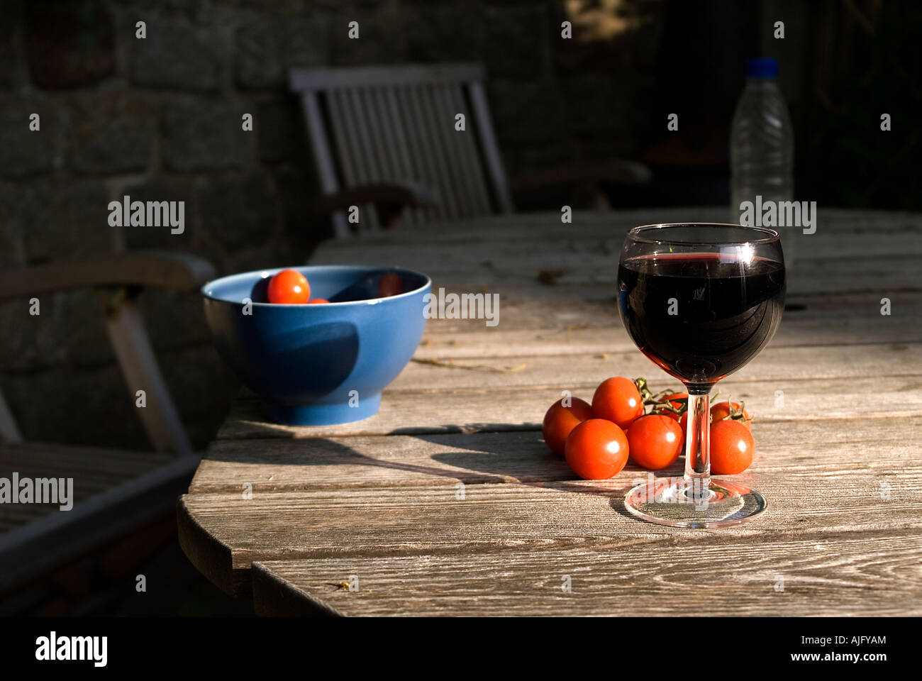 Glas Rotwein und Tomaten in einer Stockfoto