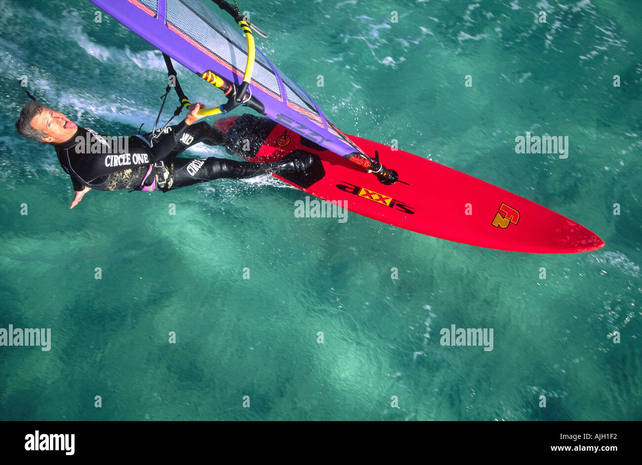 Luftaufnahme eines Windsurfers Segeln eine übergeben Zunge ragte in klaren smaragdgrünen Wasser Stockfoto