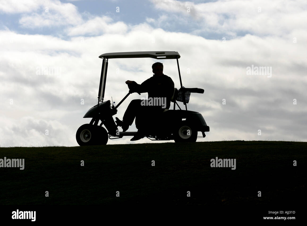 Silhouette eines Golfers auf seinem Golfbuggy auf dem Ailsa Golfplatz im Trump Turnberry Resort. Stockfoto