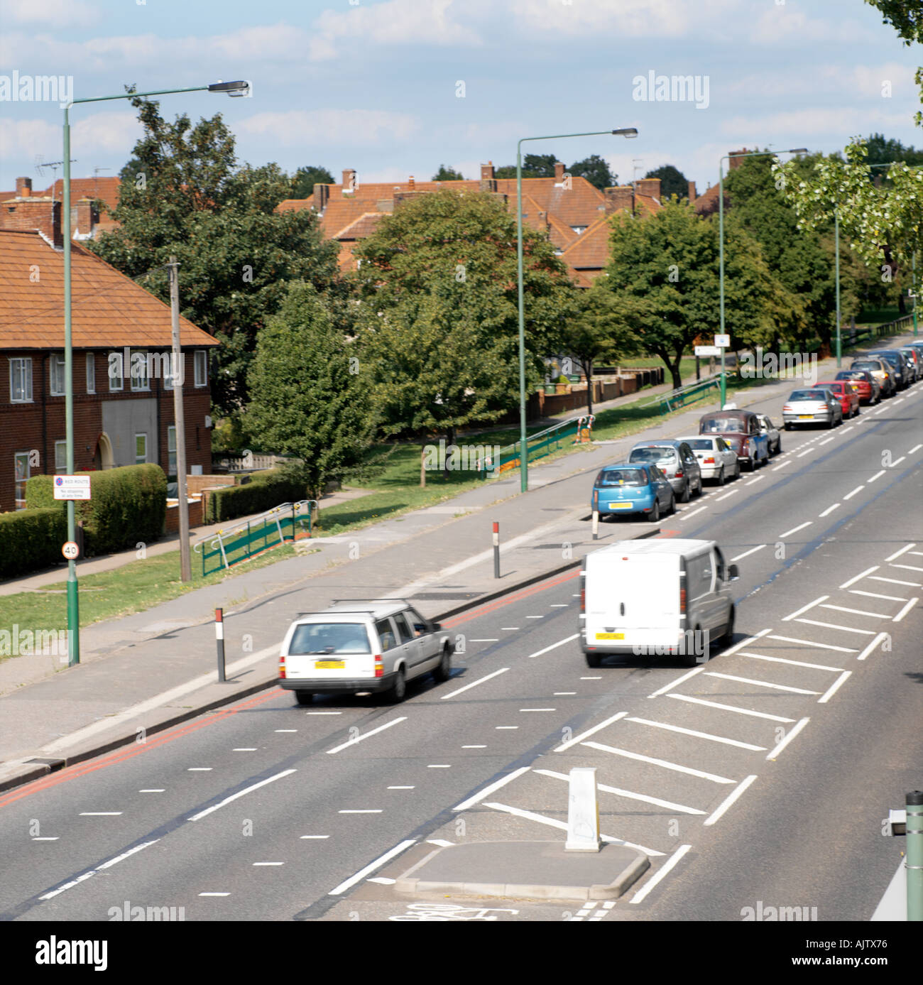 Zweispurige Straße mit Häusern rot Verkehrsweg in Rosehill Surrey England Stockfoto