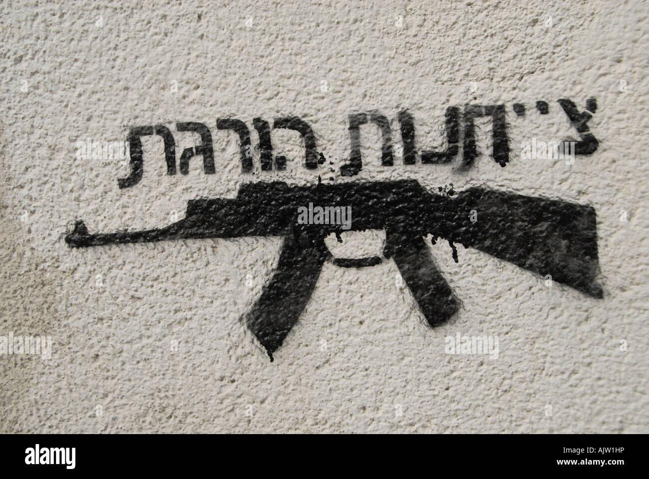 Anti-Kriegs-Graffiti mit einem AK-47 Kalaschnikow Maschinengewehr mit einer Schrift in Hebräisch, auf der steht "Gehorsam tötet" in Tel Aviv Israel Stockfoto