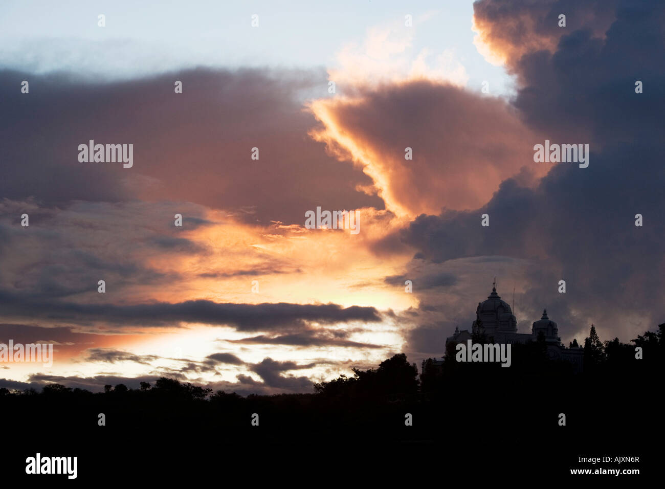 Sonnenuntergang Gewitterwolken über indischen Ashram-Gebäude. Puttaparthi, Andhra Pradesh, Indien Stockfoto