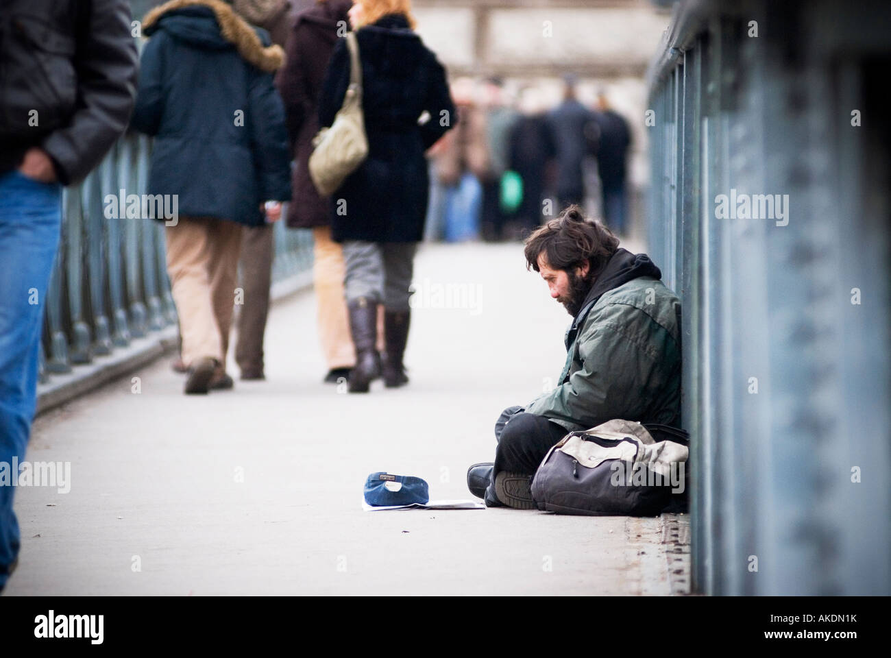 Bettler sitzt am Széchenyi Kettenbrücke als Gruppen von Menschen vorbei, Budapest, Ungarn Stockfoto