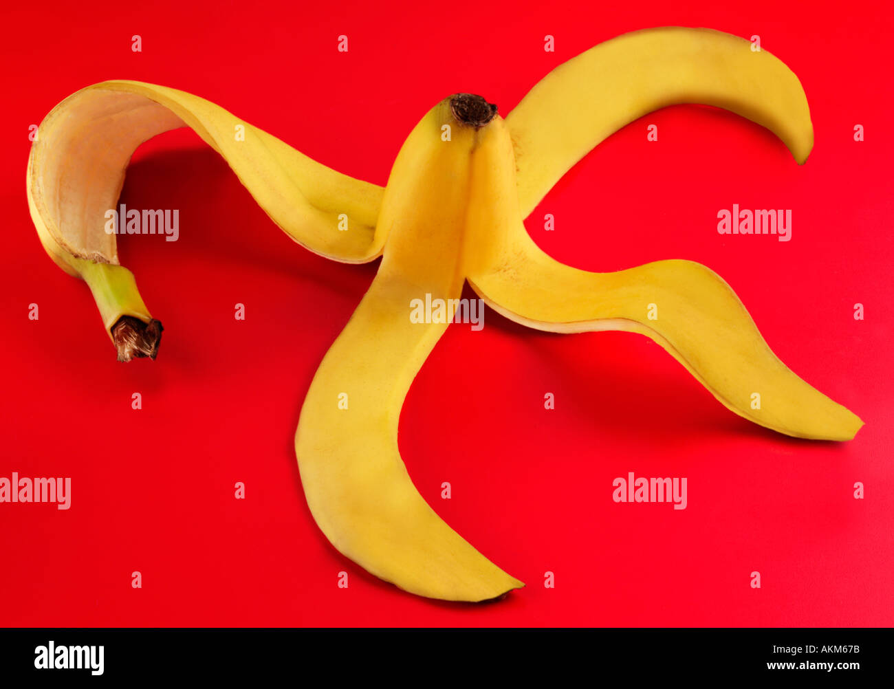 GEÖFFNETE BANANENSCHALE AUF ROTEM GRUND Stockfoto