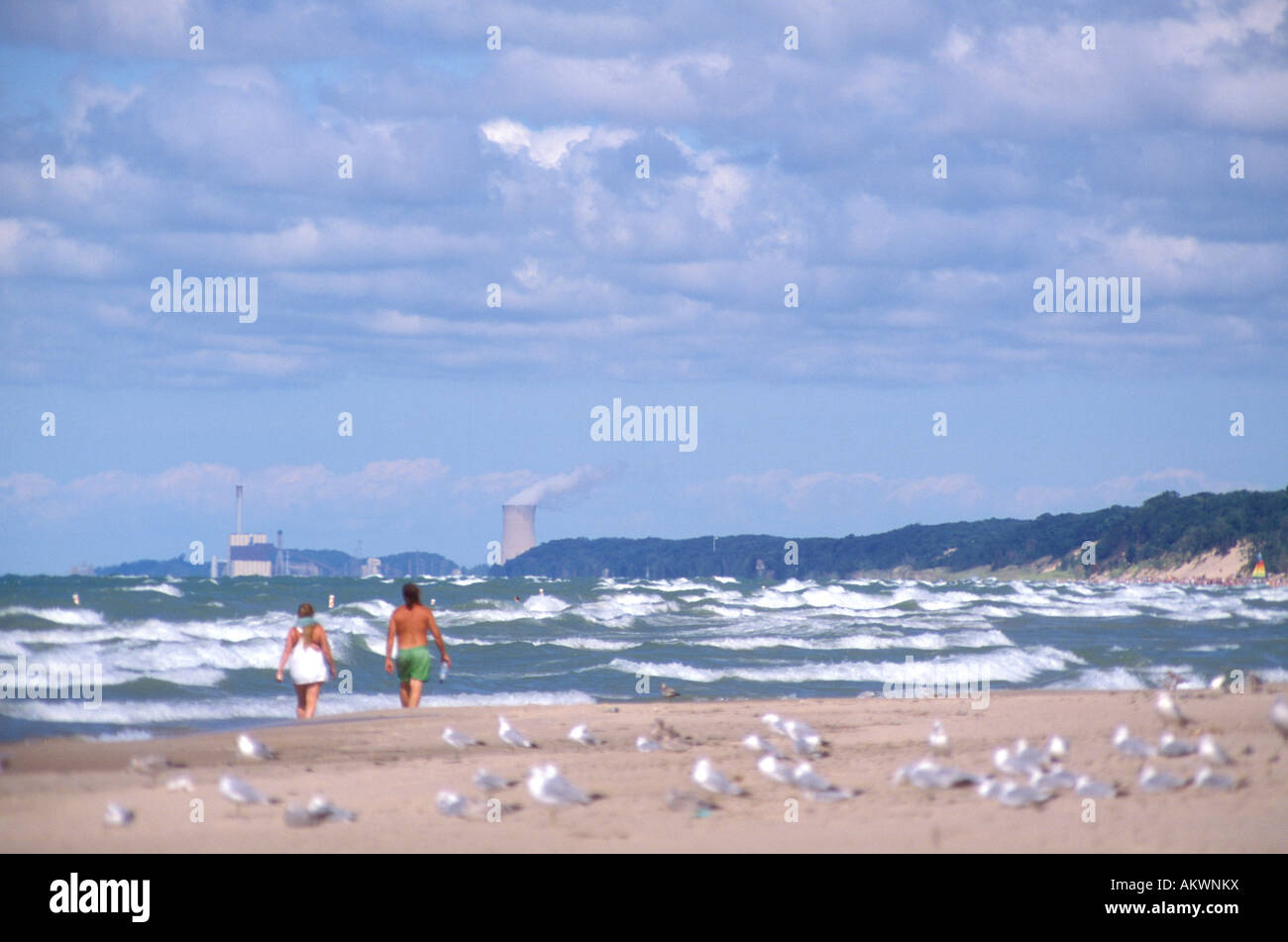 Menschen zu Fuß am Strand entlang und Lake Michigan in Indiana Dunes National Lakeshore mit Triebwerk Kühlturm im Hintergrund Stockfoto