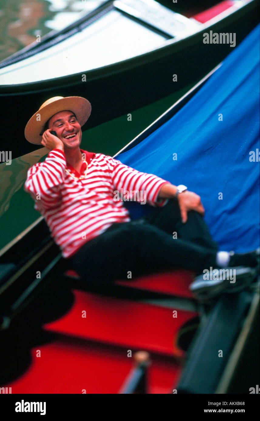 Gondoliere in seine Gondel sitzen und reden auf seinem Handy in Venedig Italien Stockfoto