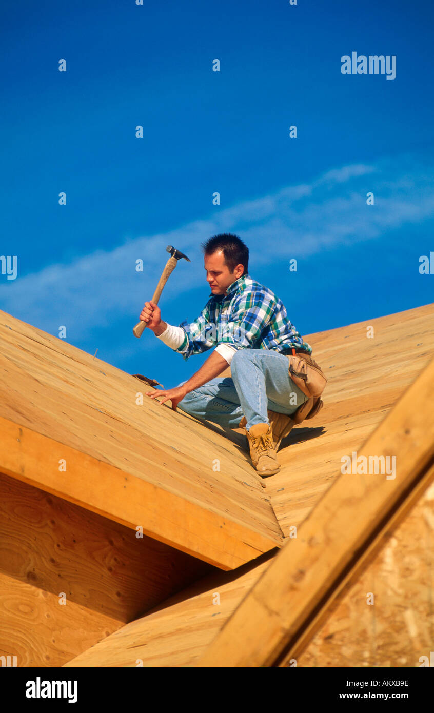 Arbeiten auf dem Dach eines neuen Hauses im Bau Schreiner Stockfoto