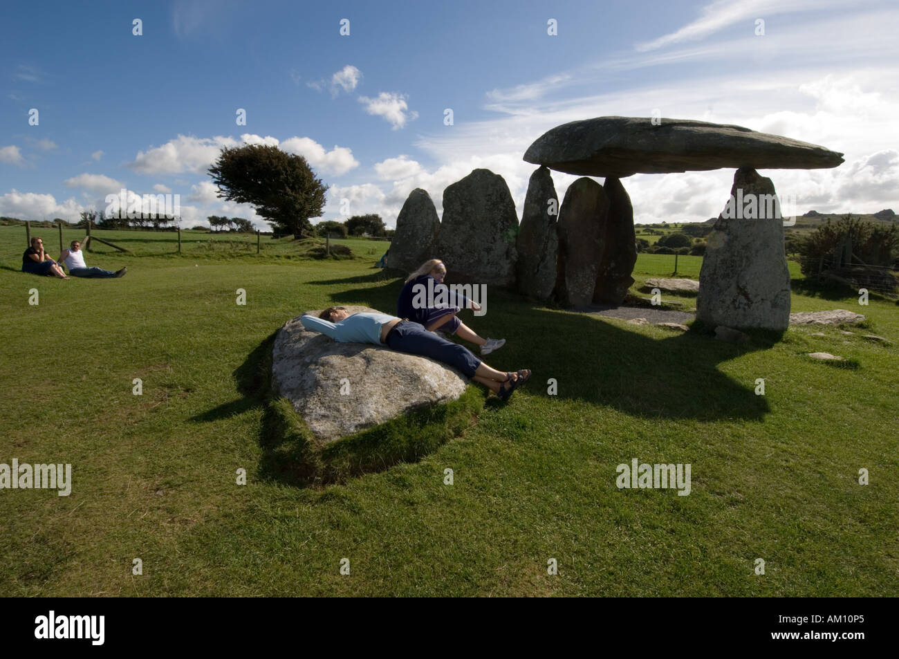 Menschen entspannen auf den Steinen bei Pentre Ifan neolithischen Steinzeit Beerdigung Hügel Newport Pembrokeshire Wales UK Stockfoto