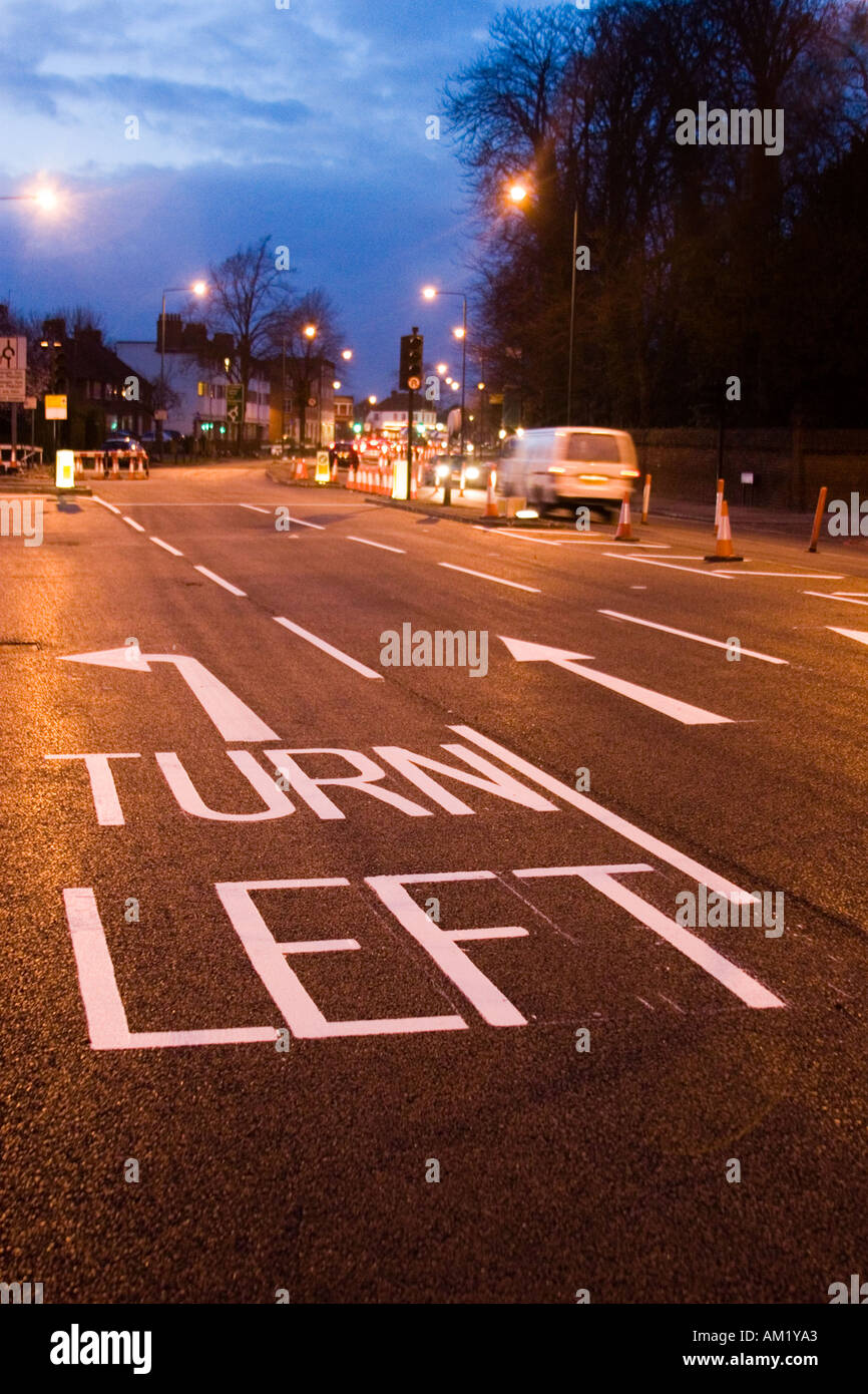 Straße Szene mit drehen links Markierungen in der Abenddämmerung in Großbritannien Stockfoto