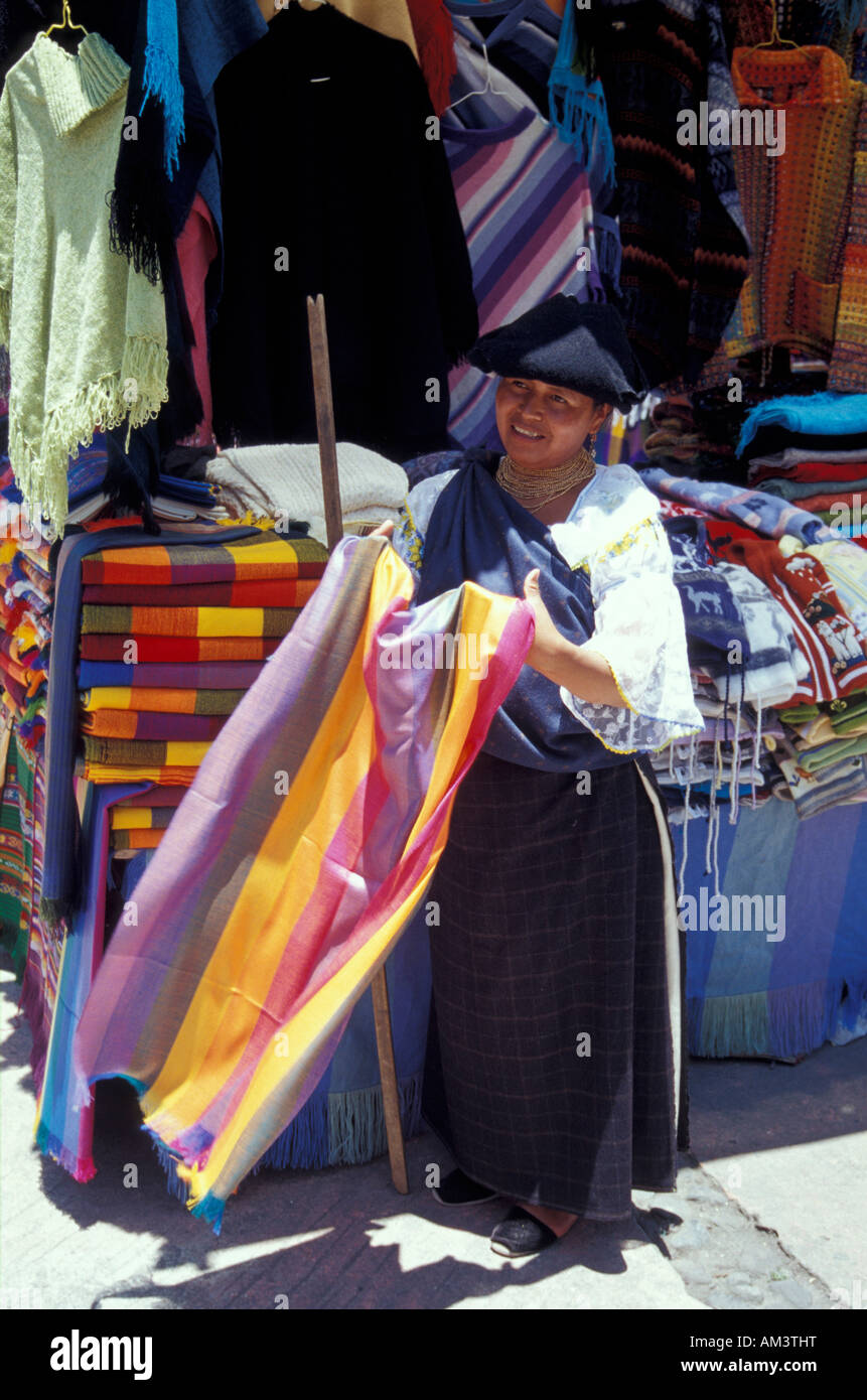 Indigene Frau verkaufen Textilien auf dem Kunsthandwerk-Markt in Poncho Plaza, Otavalo, Ecuador Stockfoto