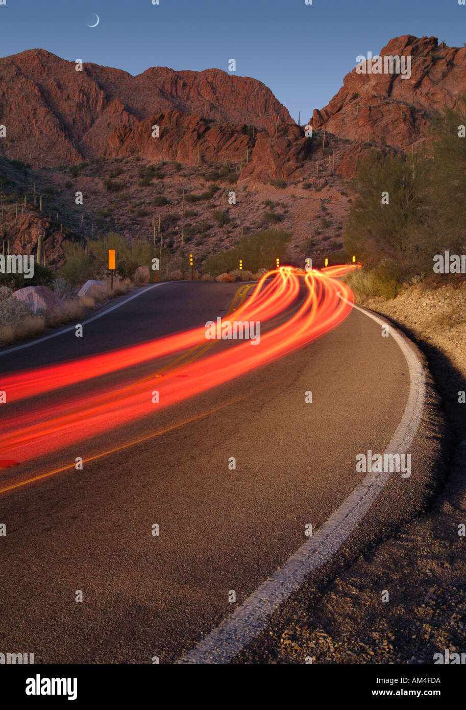 Lichtspuren von Autos auf einer einsamen Straße in Arizona. Dies ist Gates Pass in Tucson Stockfoto