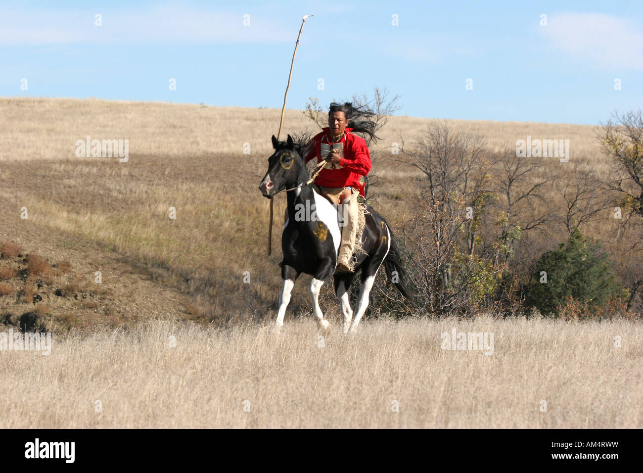 Eine Native American Indian Reiten Reiten auf der Suche nach Ememies durch die Prärie von South Dakota Stockfoto