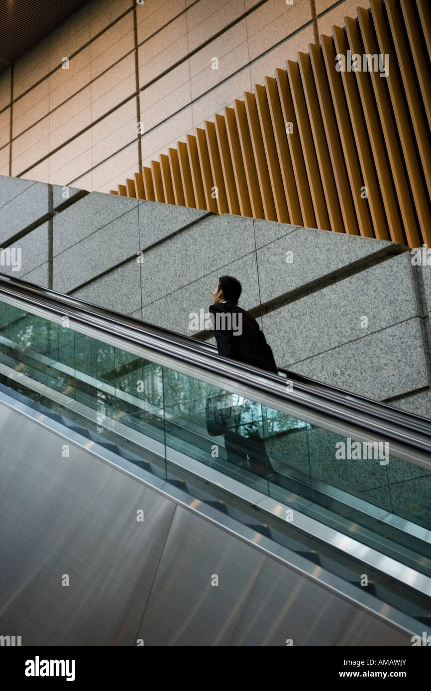 Ein Mann bewegt sich eine Rolltreppe Stockfoto