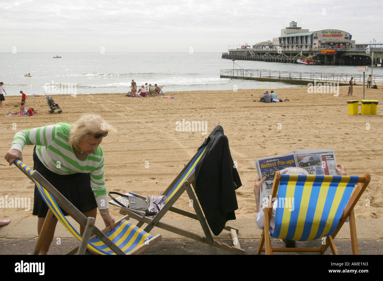 Eine ältere Frau legt ihr Liegestuhl am Meer, Bournemouth, Dorset, Großbritannien. September 2006. Stockfoto