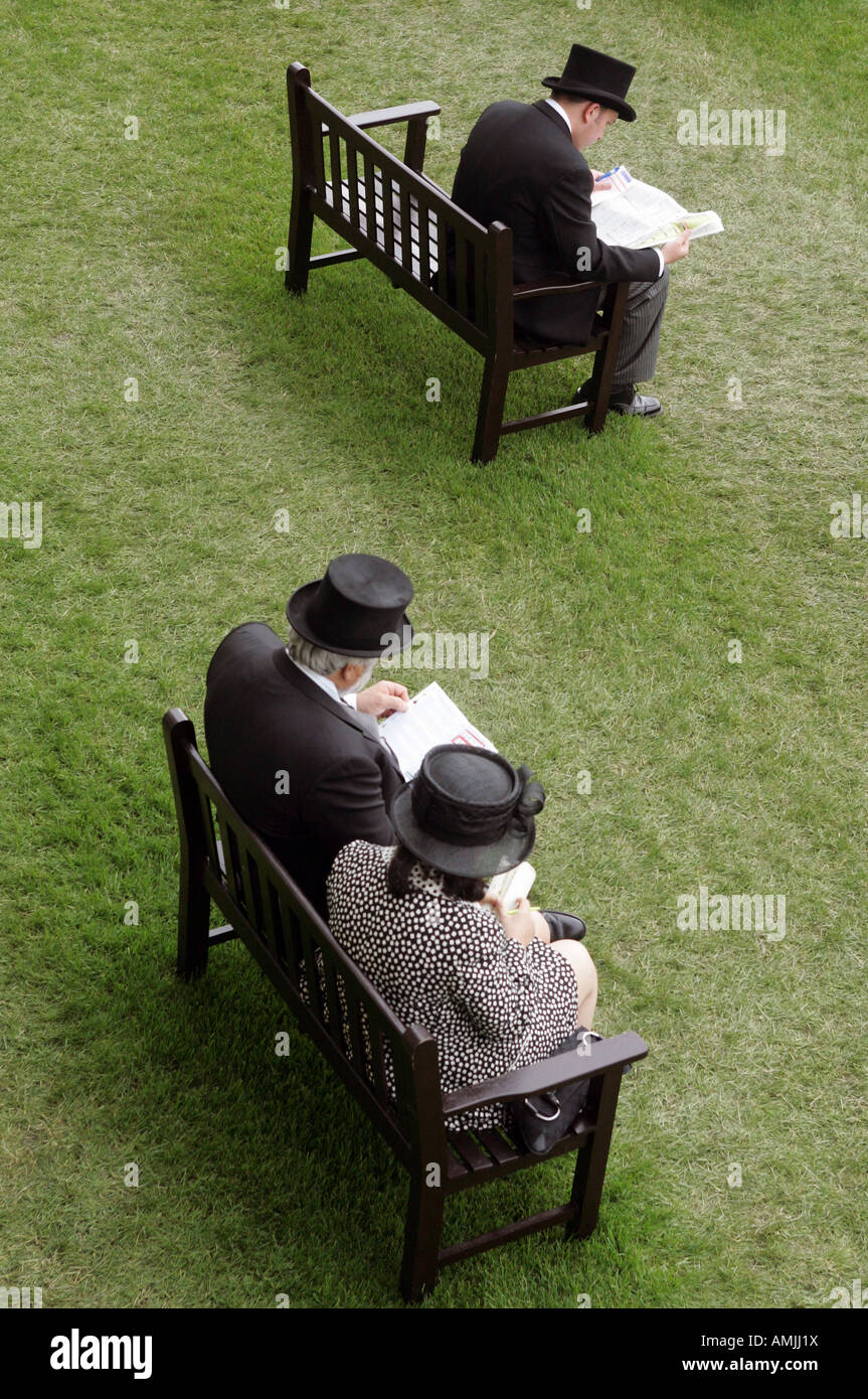 Menschen sitzen auf Bänken am Royal Ascot Pferderennen, York, Großbritannien Stockfoto