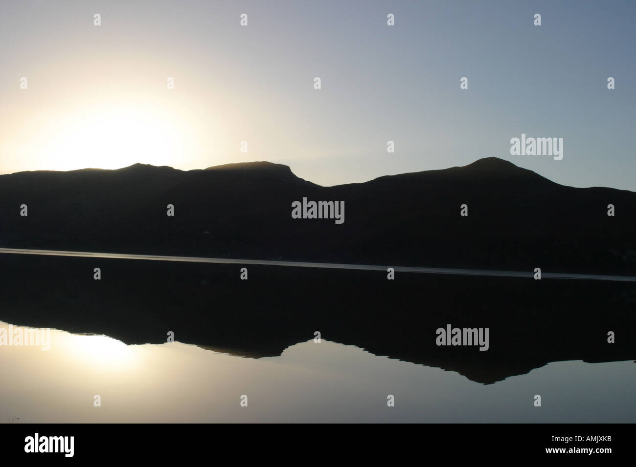 Ein Lager fotografieren der Sonnenuntergang über den Bergen im Winter auf dem Derwent Wasser in den Lake District Cumbria Stockfoto