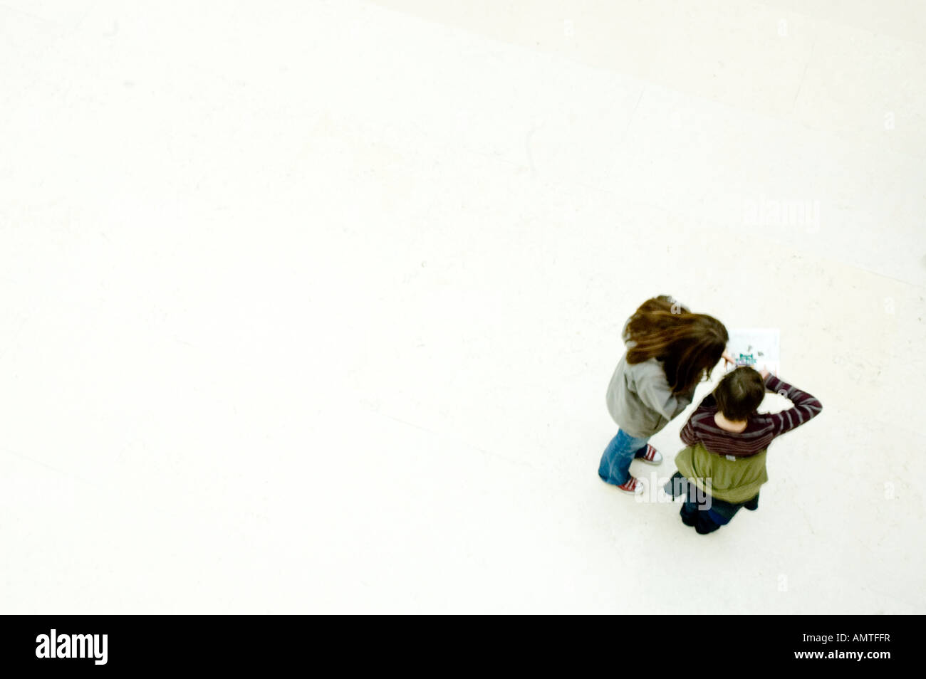British Museum Great Court, die zwei jungen Touristen eine Anleitung gelesen verschwommen Bewegung London Stockfoto