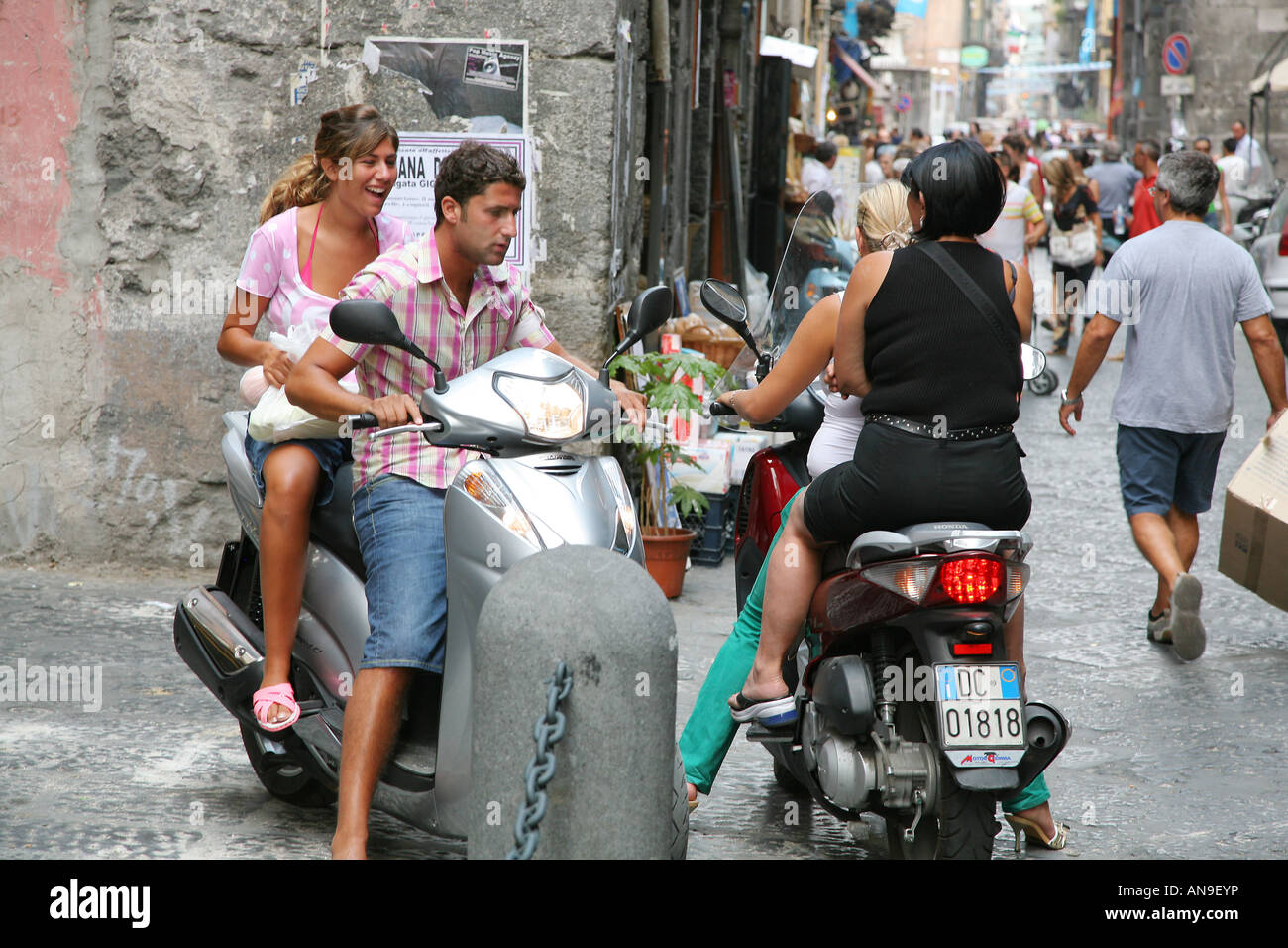 Ein paar auf einem Roller in der Altstadt von Neapel Italien Stockfoto