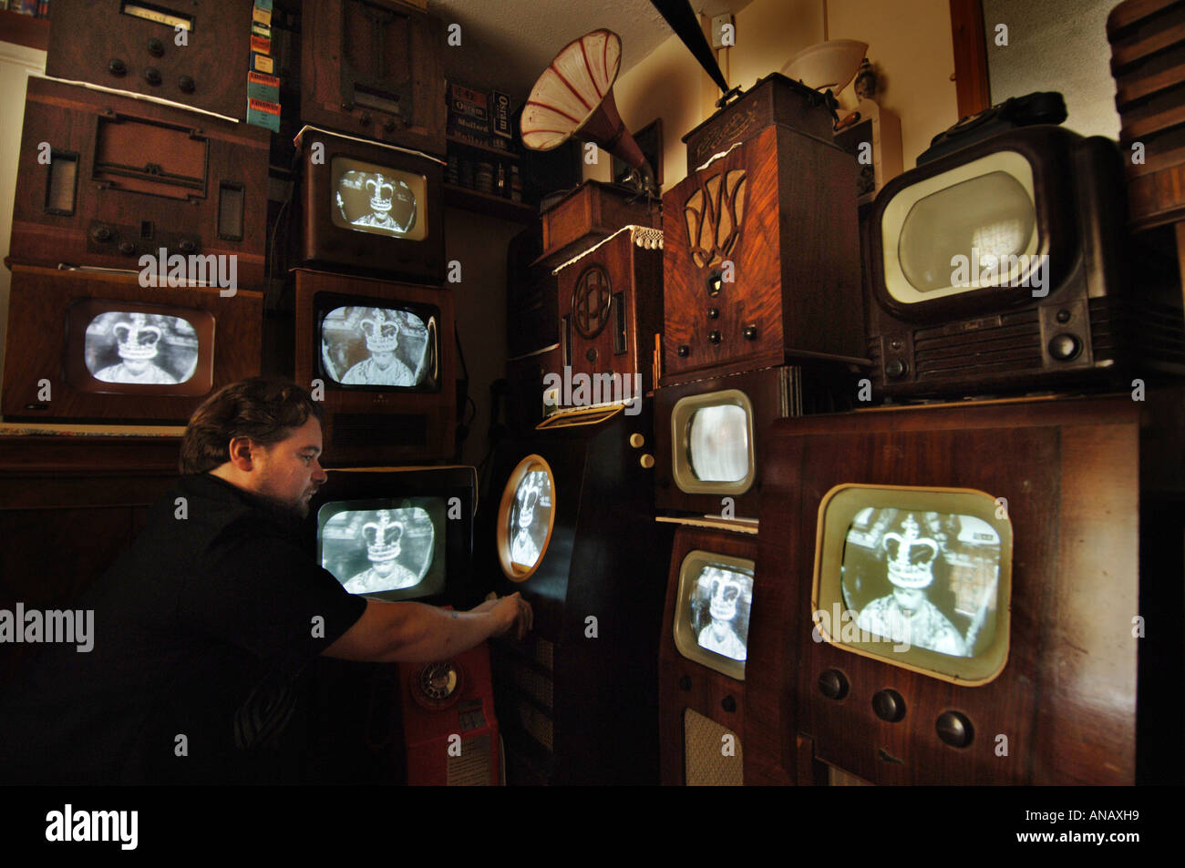 Alte TV-Sammler Peter Carlton Melodien eines seiner 14 Jahrgang tvs zu einem Video der Krönung von Queen Elizabeth 11 Stockfoto