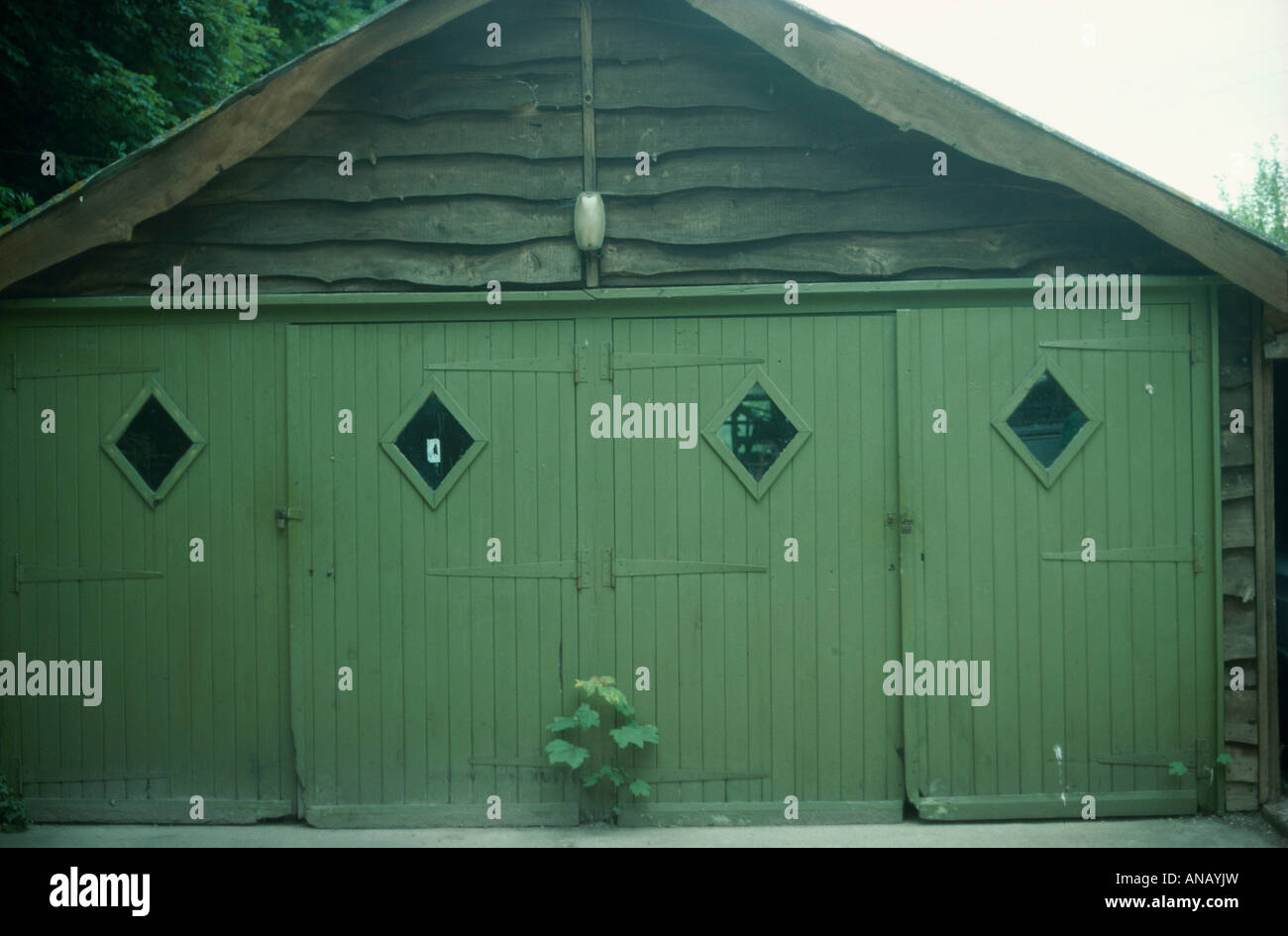 Nahaufnahme eines alten altmodischen Garage mit grünen Türen Stockfoto