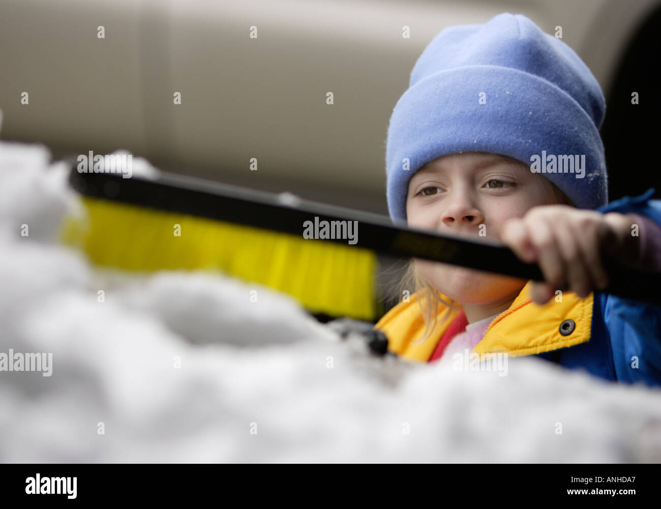 Kind, die Beseitigung von Schnee von einem Auto Stockfoto