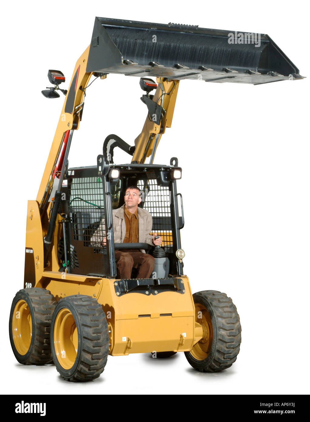 ein kleiner Bagger mit dem Fahrer in Stockfoto