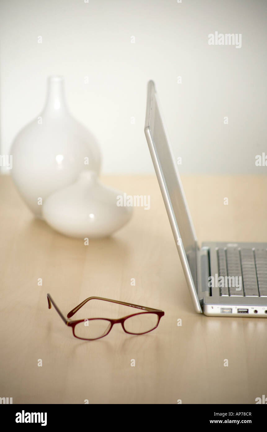 Laptop-Computer mit Brille auf modernen Schreibtisch einfach sauber vertikalen Raum für Typ Stockfoto