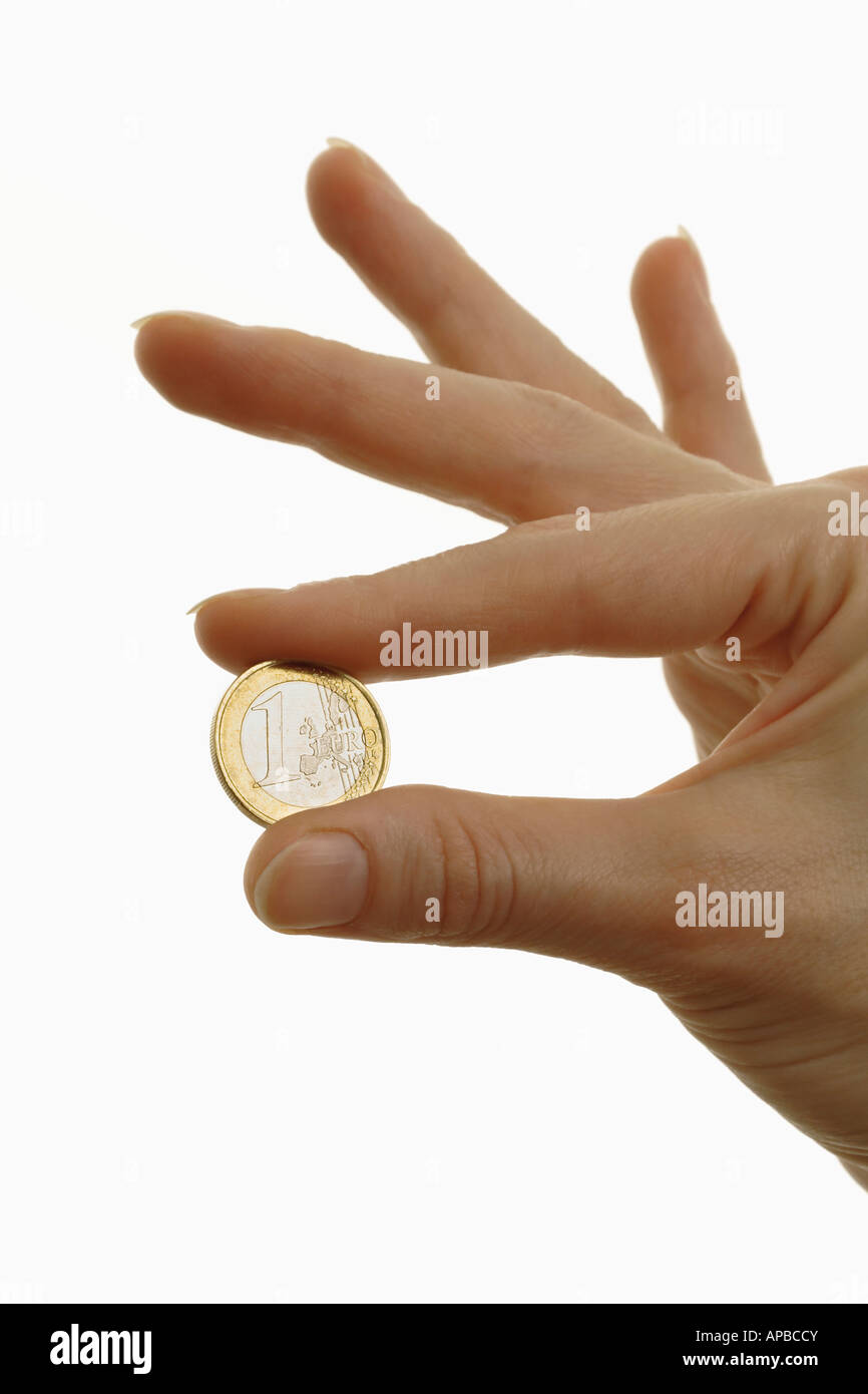 Hand, die 1 Euro Münze europäische Währung Geld Stockfoto