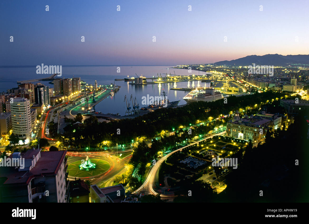 Nacht-Blick über den Paseo del Parque und Hafen Malaga Andalusien Spanien im Schatten von Palmen Stockfoto