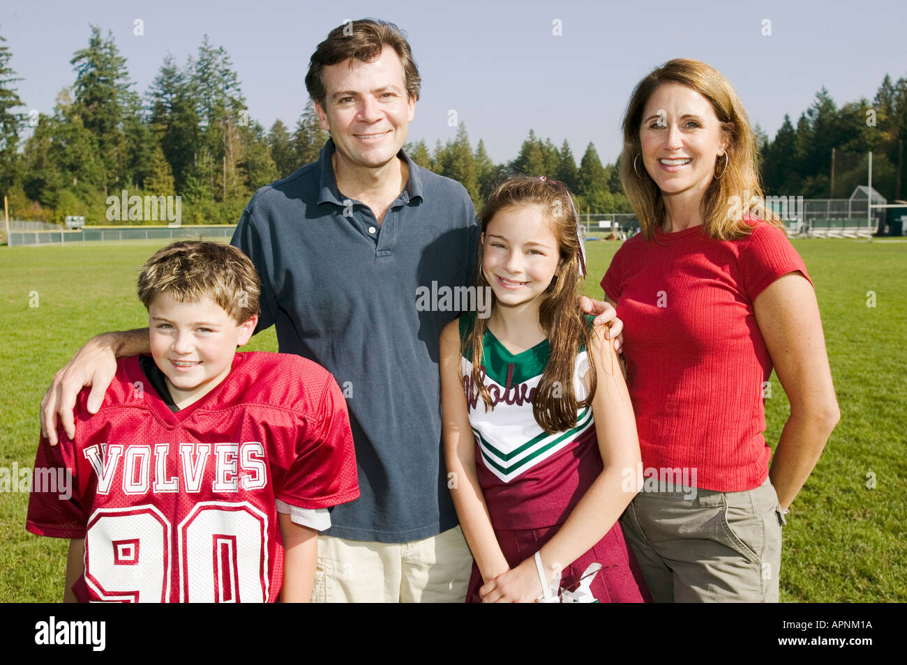 Football-Spieler und Cheerleader mit Eltern Stockfoto