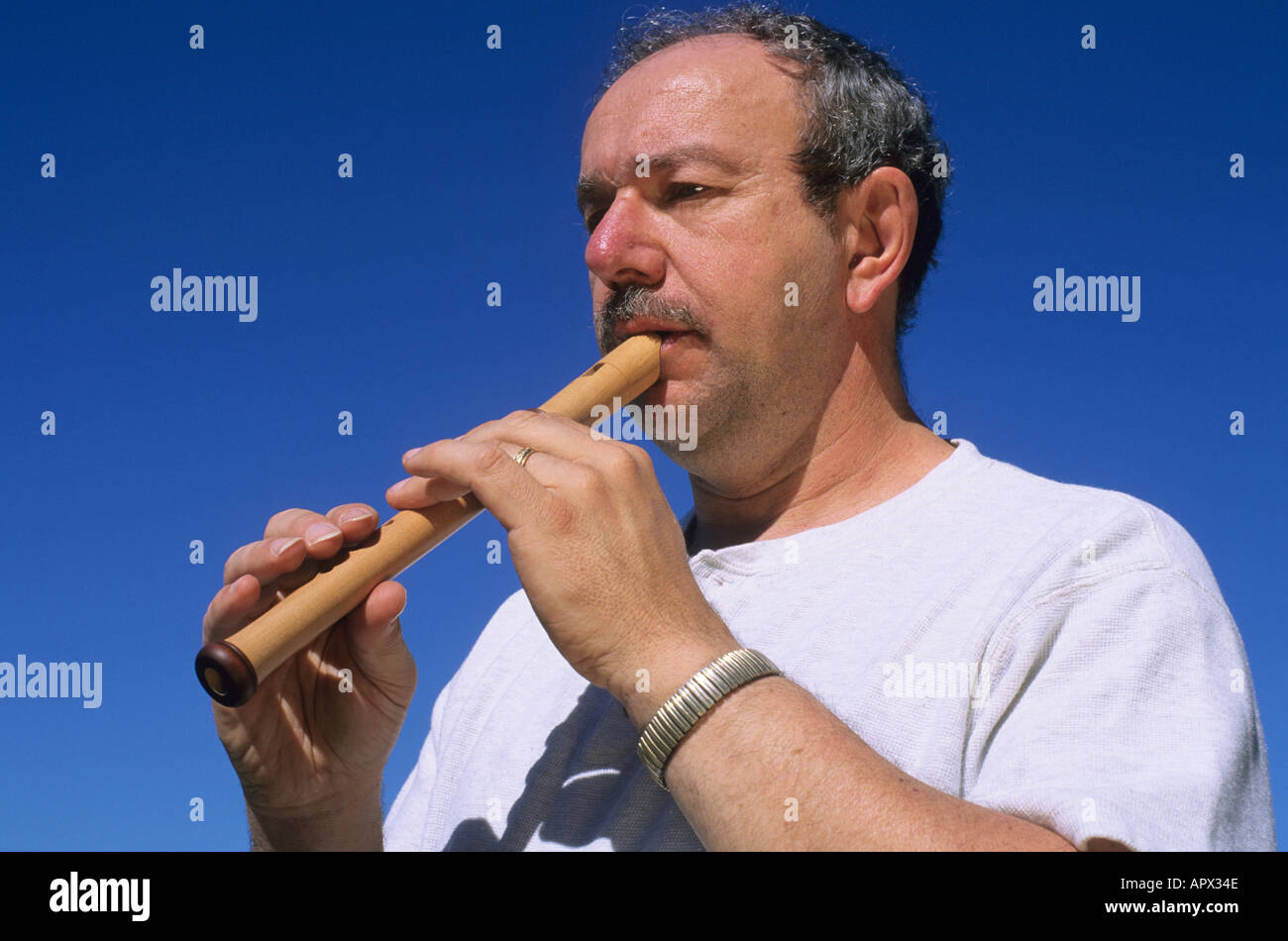 Ein Mann spielt eine Sopranblockflöte Stockfoto