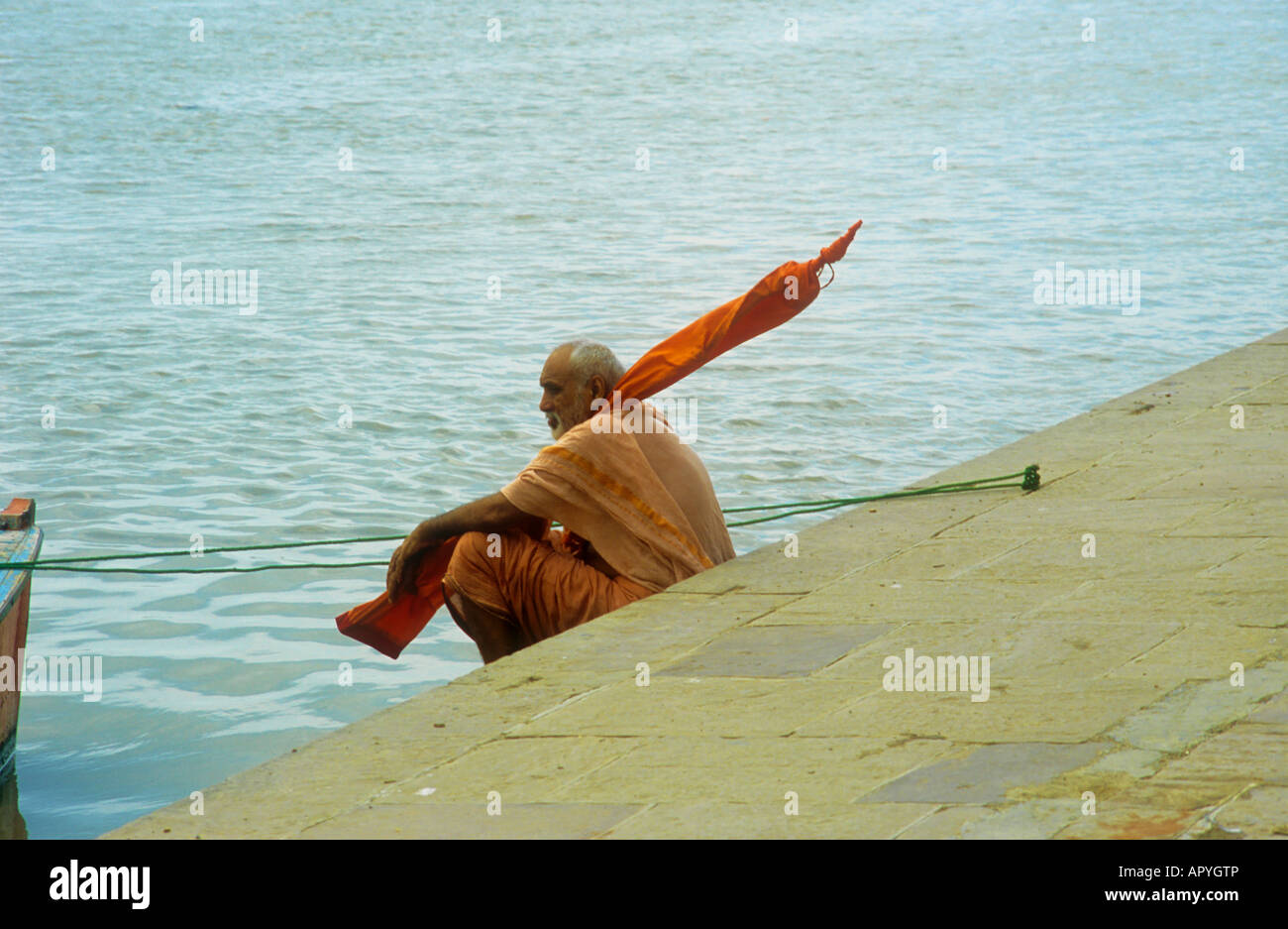 Sadhu-Mann sitzt am Ufer des Ganges in Varanasi, Indien Stockfoto