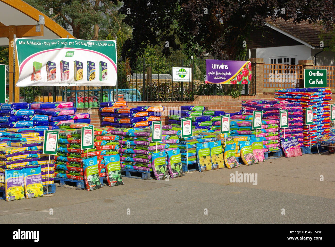 Kunststoffsäcke mit Kompost auf Paletten am Eingang des Einzelhandelsgeschäfts Essex England UK Stockfoto