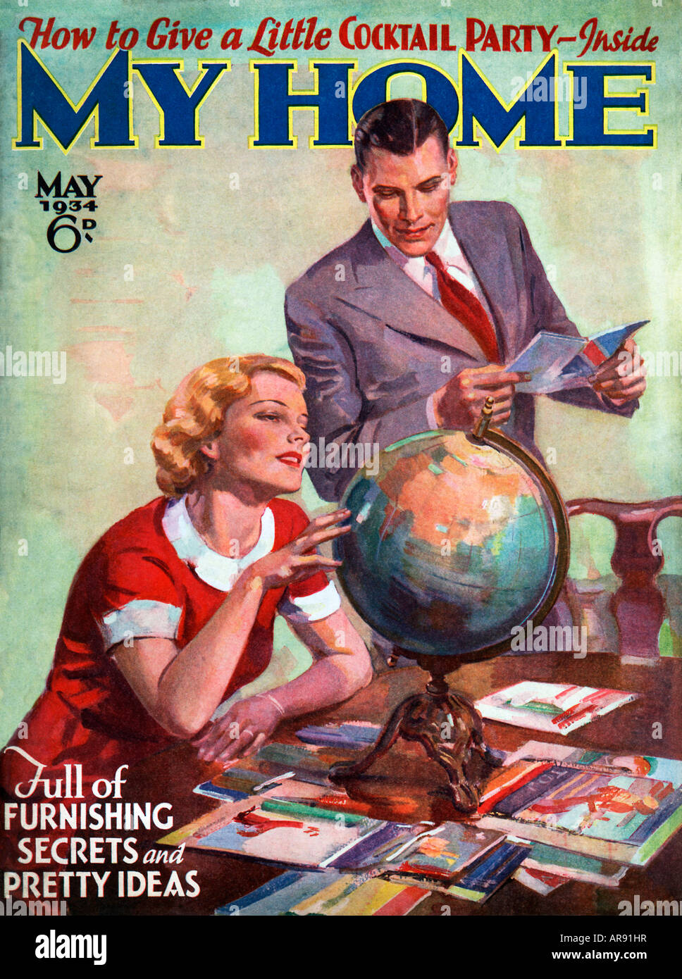 Wo In der Welt ein junges Paar machen ihre Urlaubspläne auf einem Globus in der 1934 Abdeckung der englischen My Home Magazin Stockfoto