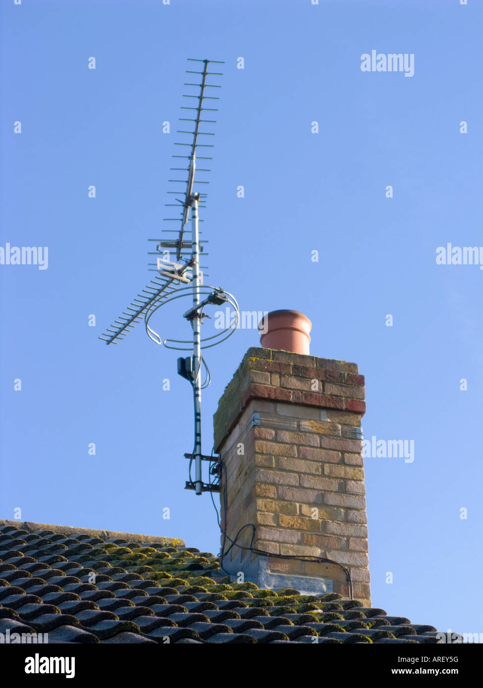 Farbbild auf ein Dach und Chimley verfügt über eine tv-Antenne befestigt ist, klaren, blauen Himmel Stockfoto