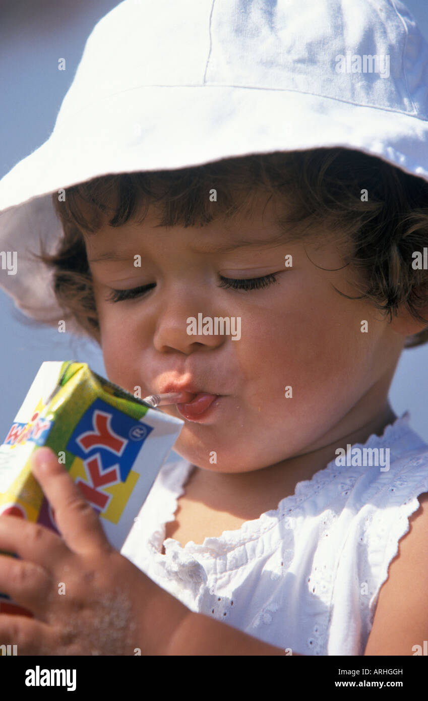 Kleines Mädchen ist mit einem Strohhalm trinken. Stockfoto
