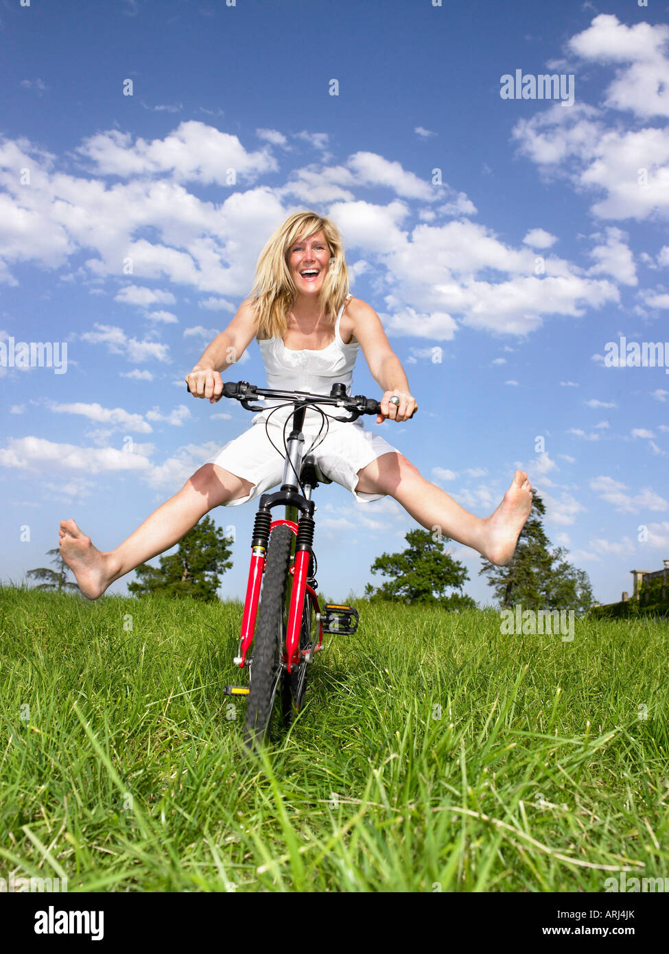 Frau spielt mit dem Fahrrad Stockfoto