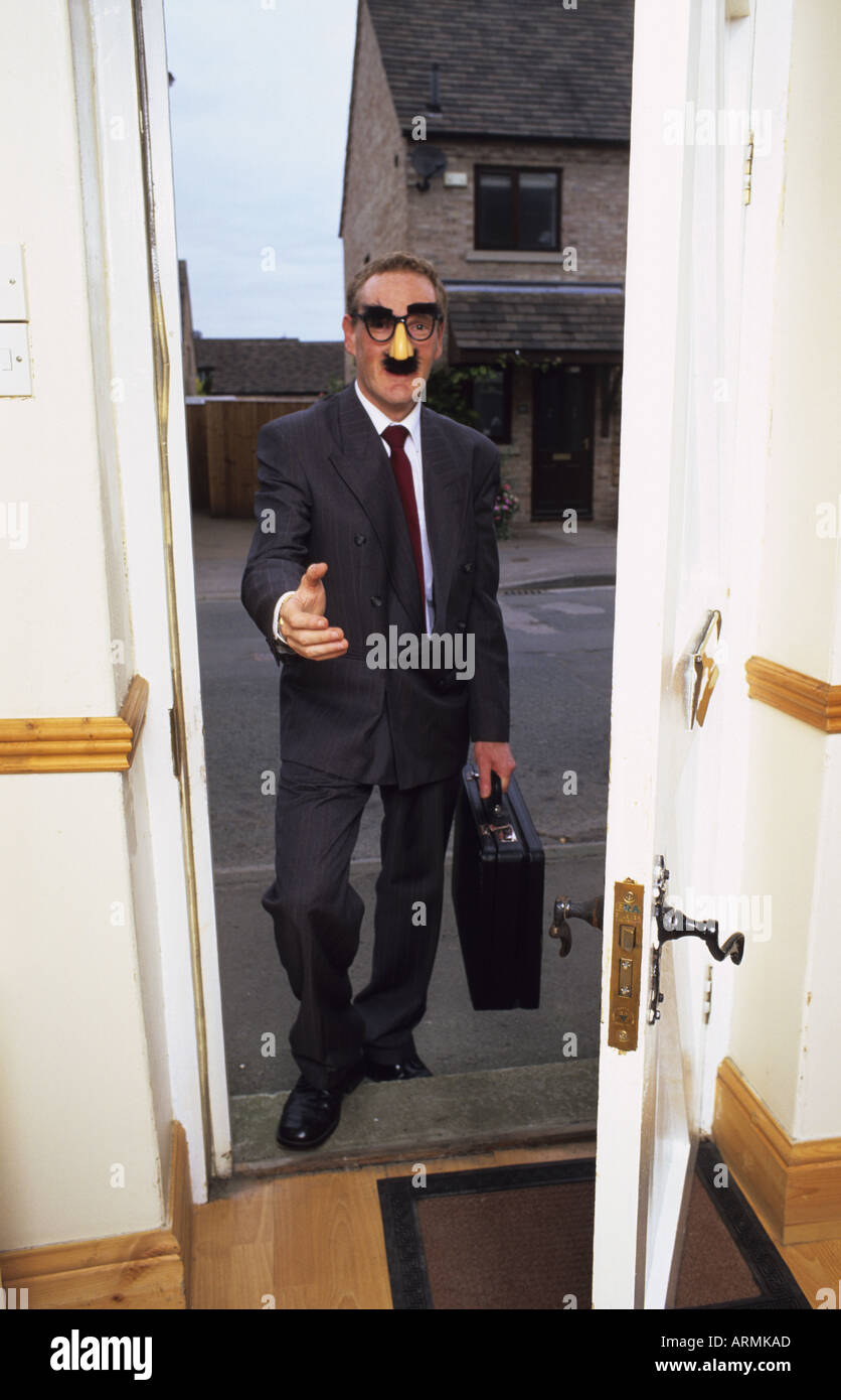 betrügerische Geschäftsmann steht vor Tür in Personen zu Hause lassen wollen Stockfoto
