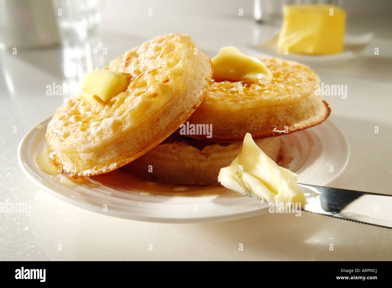 Traditionelle hot Butter gerösteten Fladenbrot auf einer weißen Platte an einen Tisch setzen, mit zerlassener Butter bereit zu essen Stockfoto